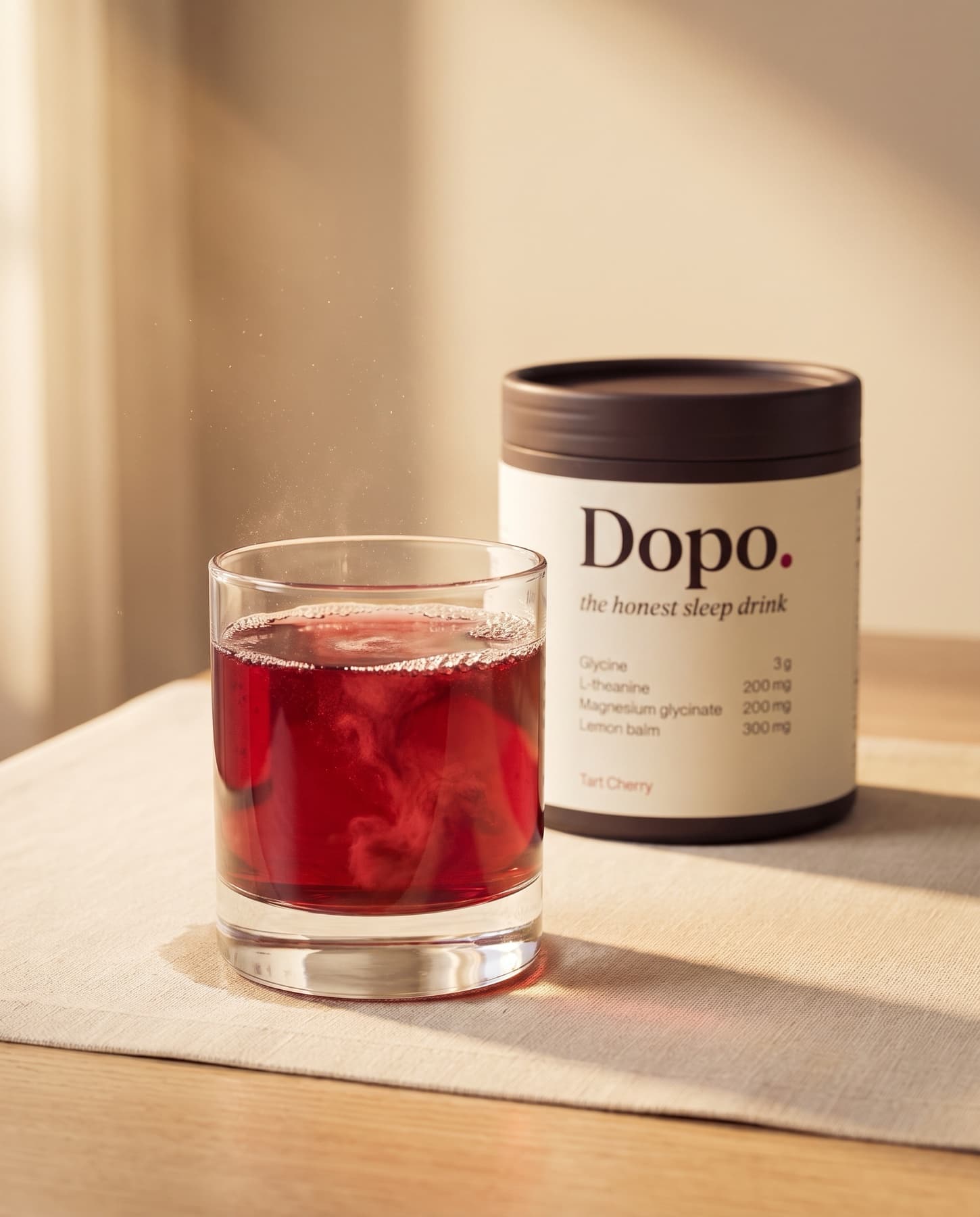 Pre-production concept rendering of a tumbler of deep ruby Dopo with the planned tub behind it in warm evening light